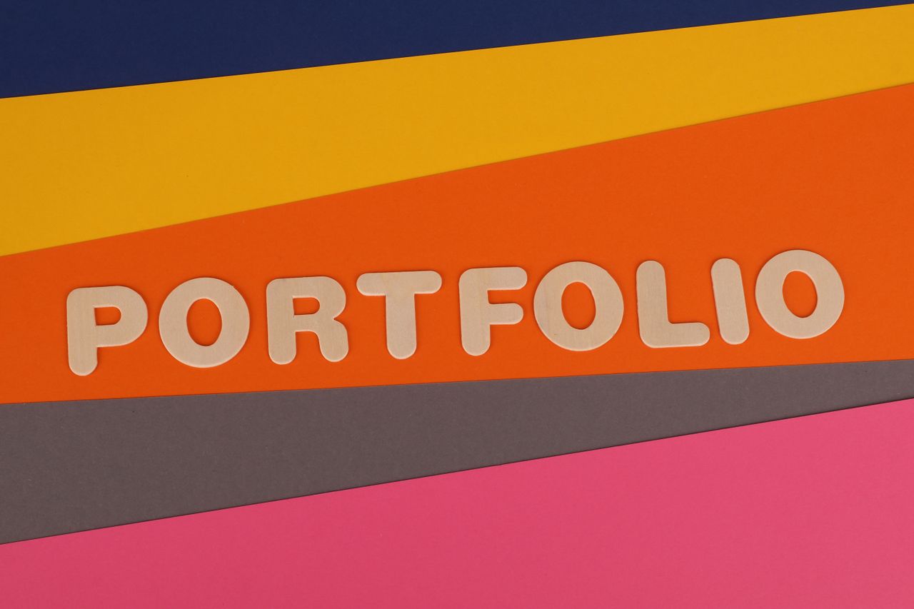 A vibrant multicolored background featuring the text 'PORTFOLIO' in pink font on colorful paper.